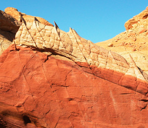 A set of compaction bands at high-angle to cross beds adjacent to the transition of the lower red and upper bluff diagenetic units of Aztec Sandstone, Valley of Fire State Park, Nevada. View due north. The lateral dimension of the photograph is about 5 meters.